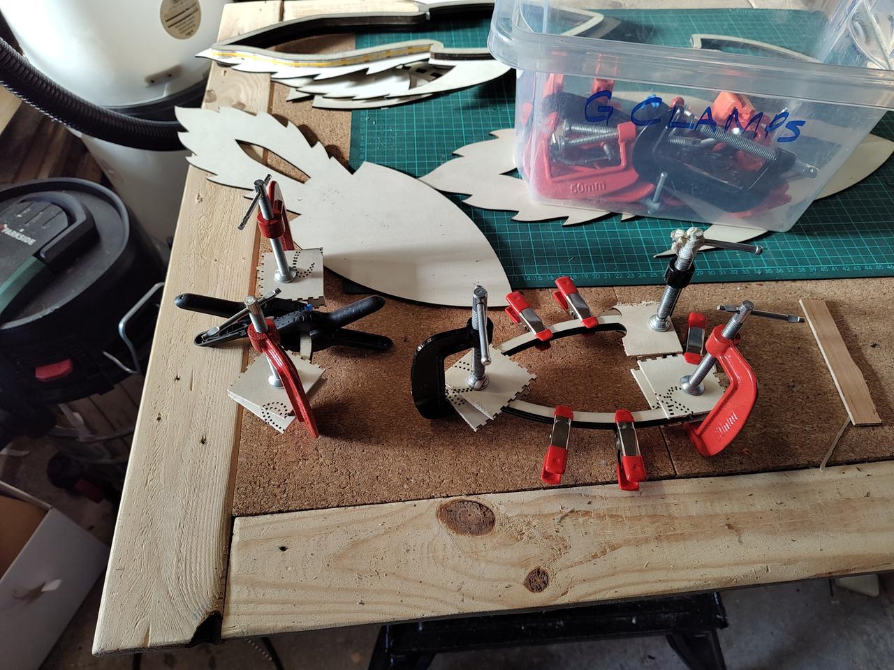 Final glue up of the supports for the upper layer, showing the large number of clamps used to get a good bond between the layers. My clamps box is visible in the top right, and behind, to the left is one of the lower layers - you can see some of the COB LED strip attached to the supports.